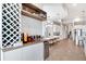 A well-equipped bar area with a wine rack, beverage cooler, and adjacent dining space with modern lighting at 15947 Vetta Dr, Bella Collina, FL 34756