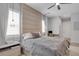Modern bedroom featuring a large upholstered headboard, plush bedding, and a dedicated workspace at 15947 Vetta Dr, Bella Collina, FL 34756