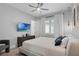 Comfortable bedroom featuring a TV, neutral tones, and ample natural light at 15947 Vetta Dr, Bella Collina, FL 34756