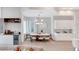 Modern dining area with bar, wine storage, contemporary lighting, and bright natural light at 15947 Vetta Dr, Bella Collina, FL 34756