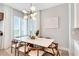 Elegant dining area featuring a modern chandelier and bright natural light at 15947 Vetta Dr, Bella Collina, FL 34756