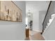 Inviting foyer with tile flooring, staircase, art, and modern light fixture at 15947 Vetta Dr, Bella Collina, FL 34756