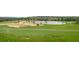View of the lush golf course landscape with mature trees and a tranquil lake, perfect for outdoor recreation at 15947 Vetta Dr, Bella Collina, FL 34756