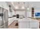 Modern kitchen with white cabinetry, quartz countertops, and stainless steel appliances at 15947 Vetta Dr, Bella Collina, FL 34756