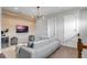 Stylish living room featuring a modern sofa, mounted TV, and elegant light fixture at 15947 Vetta Dr, Bella Collina, FL 34756