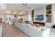 Expansive living room seamlessly connects to a modern kitchen with a large island and stainless steel appliances at 15947 Vetta Dr, Bella Collina, FL 34756