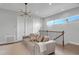 Cozy living area featuring a comfortable sofa, modern lighting, and natural light at 15947 Vetta Dr, Bella Collina, FL 34756