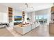Stylish living room with a modern fireplace, sleek shelving, and sliding glass doors at 15947 Vetta Dr, Bella Collina, FL 34756