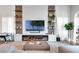 Stylish living room features a fireplace, large TV, custom built-ins, and a comfortable seating arrangement at 15947 Vetta Dr, Bella Collina, FL 34756