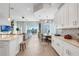 Bright, open living space with kitchen island, dining area, and comfortable seating at 15947 Vetta Dr, Bella Collina, FL 34756