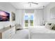 Bright main bedroom with balcony, TV, and plush bedding at 15947 Vetta Dr, Bella Collina, FL 34756