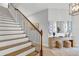Elegant staircase with wooden treads, wrought iron railings, and stylish decor at 15947 Vetta Dr, Bella Collina, FL 34756