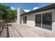 Spacious wooden back deck, great for entertaining, with clear glass sliding doors at 1617 Hallcrest Dr, Deltona, FL 32725