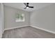 Bedroom with natural light, ceiling fan, updated flooring, and a clean, neutral palette at 1617 Hallcrest Dr, Deltona, FL 32725