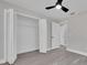 Bedroom featuring closet with bi-fold doors, ceiling fan, and updated flooring at 1617 Hallcrest Dr, Deltona, FL 32725