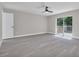 Spacious bedroom with new floors, ceiling fan, sliding doors to a private deck, and closet at 1617 Hallcrest Dr, Deltona, FL 32725