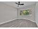 Bedroom featuring bay window, updated flooring, ceiling fan, and closet with bi-fold doors at 1617 Hallcrest Dr, Deltona, FL 32725