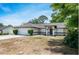 Beautifully landscaped single-story home with a two car garage, and a well-maintained yard at 1617 Hallcrest Dr, Deltona, FL 32725