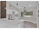 Bright kitchen showcasing contemporary white cabinets, updated countertops, and modern lighting fixtures at 1617 Hallcrest Dr, Deltona, FL 32725
