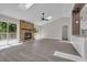 Bright, open living room with a stone fireplace, skylights, and sliding glass doors to the deck at 1617 Hallcrest Dr, Deltona, FL 32725