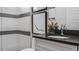 Modern bathroom with sleek vanity, black hardware, and elegant tiled shower at 1618 Bellagio Loop, Tavares, FL 32778