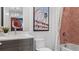 Modern bathroom features sleek vanity, framed art, and red-brick-style tiled shower with glass door at 1618 Bellagio Loop, Tavares, FL 32778
