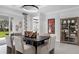 Bright dining area featuring modern lighting, stylish decor, and views of the outdoors at 1618 Bellagio Loop, Tavares, FL 32778