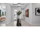 Inviting foyer with modern lighting, neutral decor, and an elegant display table enhancing the welcoming atmosphere at 1618 Bellagio Loop, Tavares, FL 32778