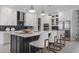 Elegant kitchen featuring a central island with seating, modern appliances, and sleek, white cabinetry at 1618 Bellagio Loop, Tavares, FL 32778