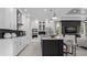 Modern kitchen with a center island, white cabinets, stainless steel appliances, and stylish pendant lighting at 1618 Bellagio Loop, Tavares, FL 32778