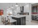 Stylish kitchen featuring a central island, sleek appliances, and elegant white cabinets with modern hardware at 1618 Bellagio Loop, Tavares, FL 32778