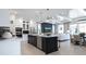 Bright, open kitchen with a center island, modern appliances, and easy access to the living and dining areas at 1618 Bellagio Loop, Tavares, FL 32778