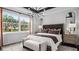 Luxurious main bedroom with a large window offering scenic views, stylish decor, and comfortable seating at 1618 Bellagio Loop, Tavares, FL 32778