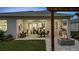 Charming outdoor patio with fire pit, built-in grill and seamless transition to indoor dining via sliding glass doors at 1618 Bellagio Loop, Tavares, FL 32778