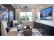 Cozy sitting room featuring comfortable chairs, a TV, and a decorative sailboat at 1618 Bellagio Loop, Tavares, FL 32778