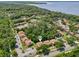 Aerial view of condo community surrounded by lush green trees with water in the background at 168 Perimeter Ct # 5C, Deltona, FL 32725