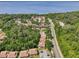 An aerial view of the community near a lake, showcasing the buildings and surrounding trees at 168 Perimeter Ct # 5C, Deltona, FL 32725