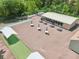Aerial view of the community clubhouse, picnic tables with umbrellas, and bocce ball court at 168 Perimeter Ct # 5C, Deltona, FL 32725