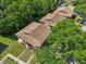 An aerial view of townhomes with brown roofs surrounded by lush trees and greenery at 168 Perimeter Ct # 5C, Deltona, FL 32725