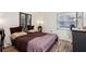 Cozy bedroom with a plush bed, wooden floors, and natural light from the window at 168 Perimeter Ct # 5C, Deltona, FL 32725