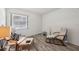 Bedroom with two chairs, wooden floors, and natural light from the window at 168 Perimeter Ct # 5C, Deltona, FL 32725
