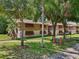 Two-story condo complex with mature trees, manicured lawn, and ground-level community sign at 168 Perimeter Ct # 5C, Deltona, FL 32725