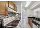 A view of the kitchen showcasing modern appliances and decorative backsplash at 168 Perimeter Ct # 5C, Deltona, FL 32725