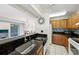 Kitchen featuring sleek countertops and modern appliances and a peek through to the living room at 168 Perimeter Ct # 5C, Deltona, FL 32725