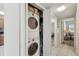Hallway laundry closet featuring a stacked washer and dryer at 168 Perimeter Ct # 5C, Deltona, FL 32725