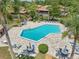 Aerial view of community pool with lounge chairs and picnic tables for summer relaxation at 168 Perimeter Ct # 5C, Deltona, FL 32725