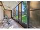 Enclosed patio with tiled floors, ceiling fan, and view of the backyard lawn at 168 Perimeter Ct # 5C, Deltona, FL 32725