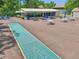 Shuffleboard court with picnic tables and umbrellas for community activities at 168 Perimeter Ct # 5C, Deltona, FL 32725