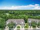 An aerial shot highlighting well-maintained townhomes near a serene lake and lush greenery at 1757 Sunset Palm Dr, Apopka, FL 32712