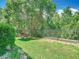 A serene backyard featuring lush greenery and a well-maintained fence at 1757 Sunset Palm Dr, Apopka, FL 32712